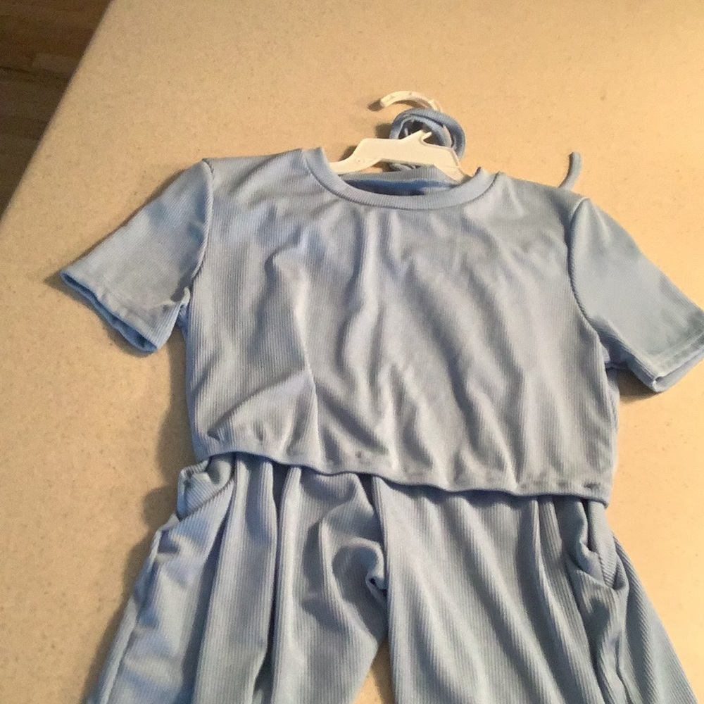 Two sets of shorts and shirts with thigh slits